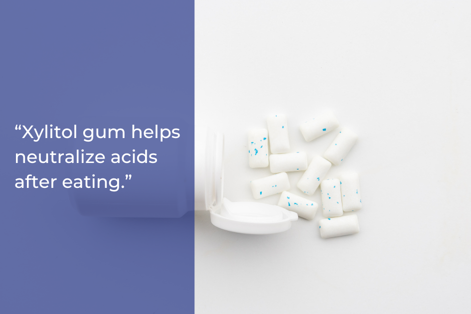 An open white gum container with white, speckled chewing gum pieces scattered beside it; a quote about xylitol gum and dental health appears on a blue background.